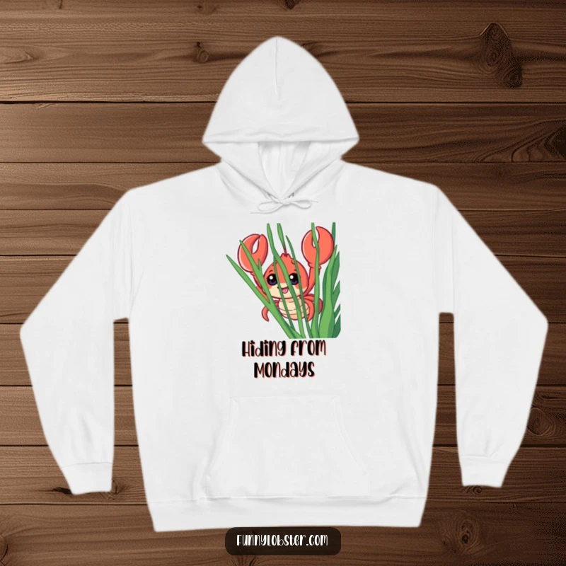Funny hoodie depicting a smiling lobster with enormous eyes, cautiously emerging from behind a veil of green seaweed, looking surprised.